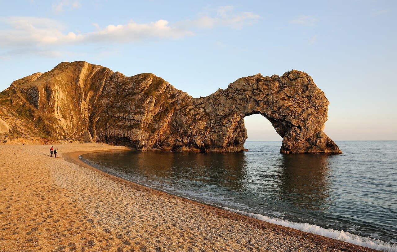 Durdle Door and its beach on the Dorset coast at sunset